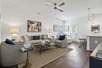 An open floor plan with wood-plank floors and ceiling fan at Turnberry Park Luxury Rental Homes in Gardendale, AL